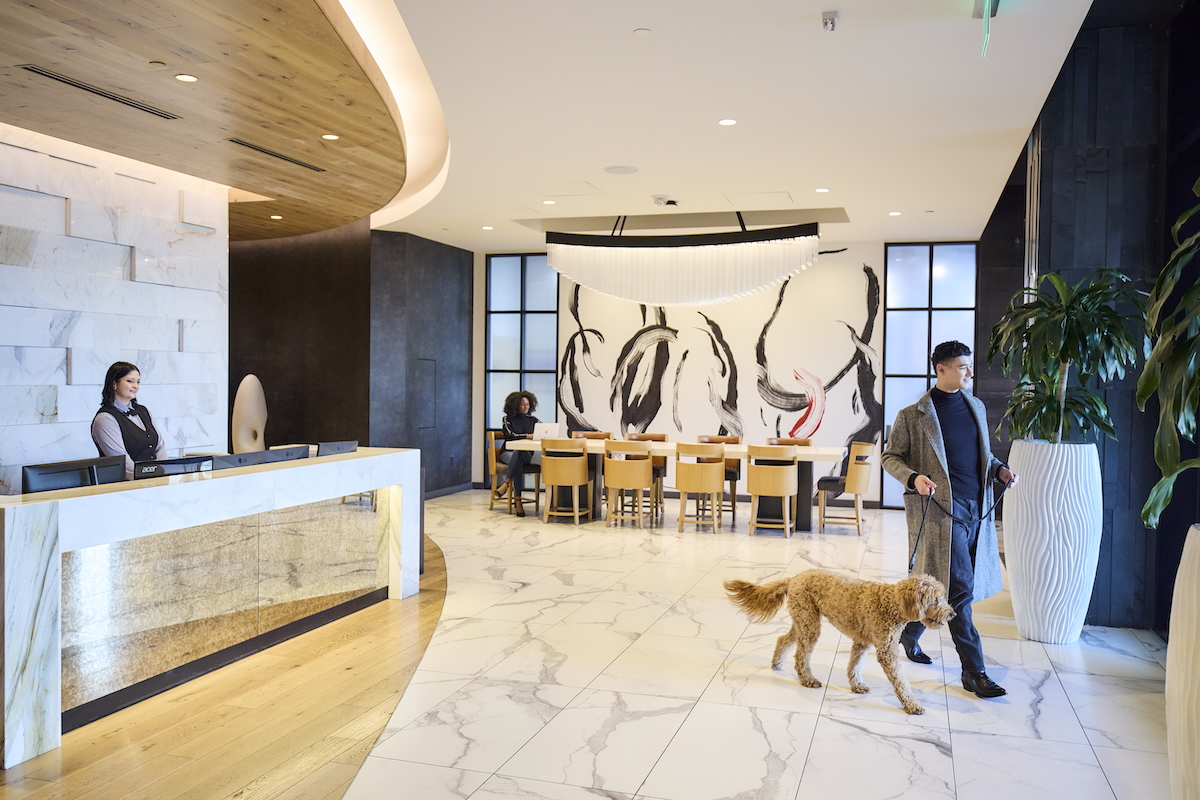 Chic lobby with man walking dog dressed for the Fall.